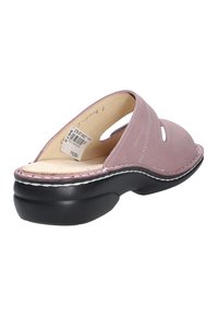 Pink leather slip-on shoe with cut-out detail, black rubber sole, and contrasting white stitching along the edge. Comfort-focused design.