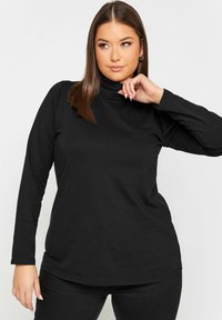 Mustat pitkät hihat turtleneck-paita, joka on valmistettu pehmeästä kankaasta ja siinä on kiinteä muotoilu sekä sileä pinta, jossa on yksinkertainen ja puhdas siluetti.