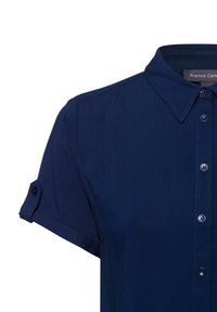Camicia a maniche corte blu navy in tessuto morbido, con colletto classico e chiusura a bottoni con bottoni coordinati e maniche arrotolate.
