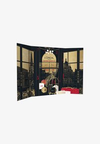 L’Oréal Paris advent calendar features a black and gold design, showing Parisian landmarks, numbers 1-12, and decorative accents.