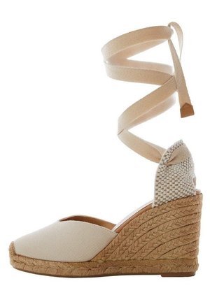 Espadrille compensée beige avec semelle en jute tressé et lien à nouer à la cheville, dotée d'un embout fermé et d'un contrefort de talon tissé.