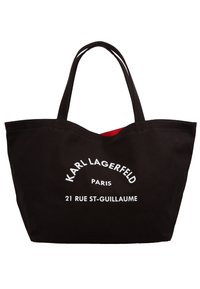 Černá plátěná taška s červenou podšívkou, s bílým potiskem textu: "KARL LAGERFELD PARIS 21 RUE ST-GUILLAUME." Dva pevné úchyty.