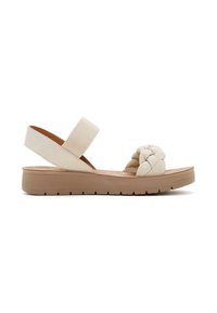 Sandal paglia chiara con parte anteriore intrecciata, cinghia elastica regolabile e suola piatta in gomma testurizzata. Presenta una suola più spessa per un migliore supporto.
