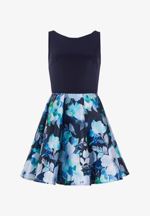 Mouwloze jurk met een aansluitende marineblauwe lijfje en een wijd uitlopende rok. De rok heeft een bloemenpatroon in tinten blauw, teal en groen.