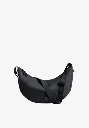 Zwarte halvemaanvormige crossbodytas met verstelbare band, ritssluiting en klein "GOT BAG"-logo op het midden van de voorkant.