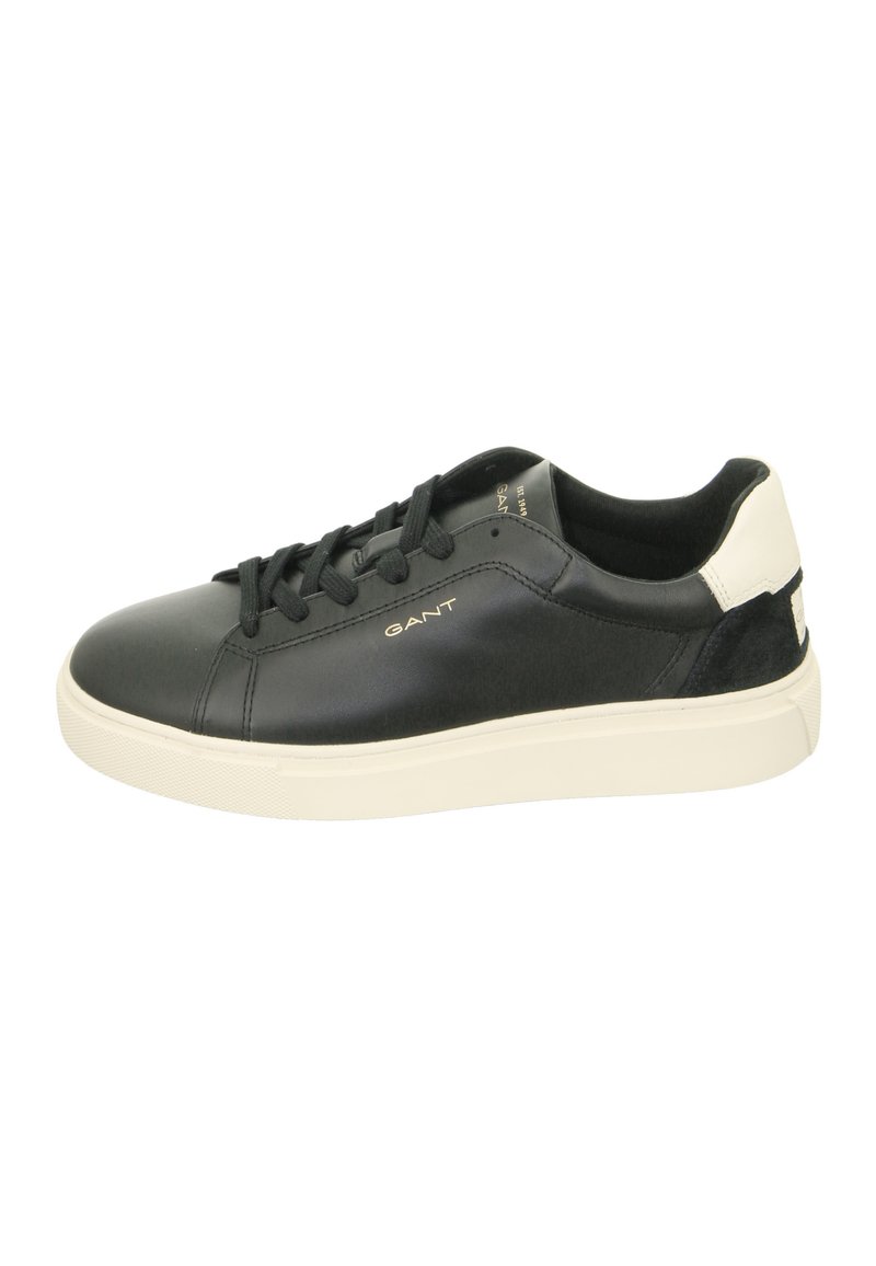 Black leather sneaker with round toe, lace-up design, white rubber sole, suede accent at the heel, and gold logo detailing on the side.