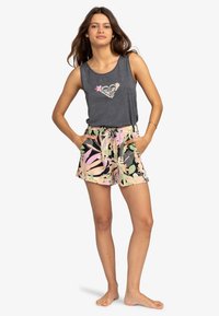 Canotta grigia senza maniche con grafica a cuore; pantaloni corti a fiori nei toni del rosa, verde e nero; vita elasticizzata; vestibilità comoda.