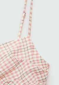 Růžová a bílá kostkovaná látka se tenkými ramínky a nařasenou texturou. Dokončeno zlatými akcenty ve švech.