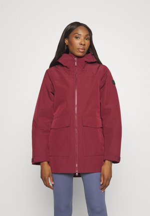 Bordová nepremokavá bunda s kapucňou, predným zipsom a dvoma veľkými vreckami. Má mierne voľný strih a dlhé rukávy.