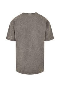Grau, T-Shirt mit kurzen Ärmeln aus Baumwolle. Hat einen Rundhalsausschnitt, eine normale Passform und eine leicht strukturierte Oberfläche. Keine sichtbaren Logos oder Muster.