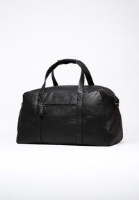 Black leather duffel bag with two sturdy handles, a zippered pocket on the front, and a smooth, matte texture. Rectangular shape.