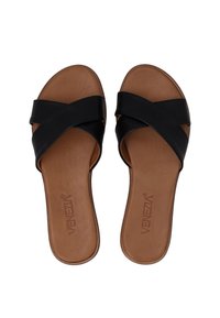 Black leather slide sandals with crisscross straps, featuring a brown textured insole and a rounded toe shape, designed for comfort.