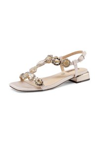Sandal flat in beige metallizzato con design a T-strap. Presenta gemme decorative e un tacco basso. Texture liscia, stile open-toe.