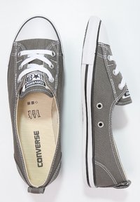 Sneaker in tela grigia con punta di gomma bianca, accentuazione nera sulla suola e lacci bianchi. Presenta il logo sulla soletta interna. Design classico a taglio basso.