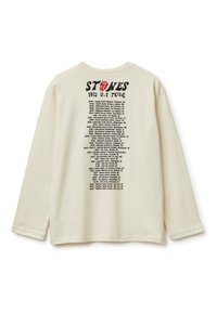 Langärmliges cremefarbenes Hemd mit einem schwarzen Druckmotiv auf der Rückseite, das "STONES 1972 U.S. TOUR" und eine Liste von Tourdaten und -orten zeigt.