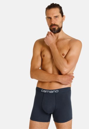 Dunkelblaue Boxershorts aus Baumwolle mit einem elastischen Taillenbund, der den weißen Text "camano" trägt. Eng anliegendes Design.
