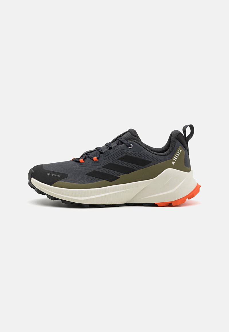 Gray and black waterproof running shoe with an olive green accent, rubber sole, and orange laces, featuring a cushioned midsole.