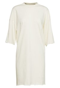 Vestido crema de gran tamaño hecho de algodón suave, con cuello alto, hombros caídos y mangas cortas. Superficie lisa y sin textura.