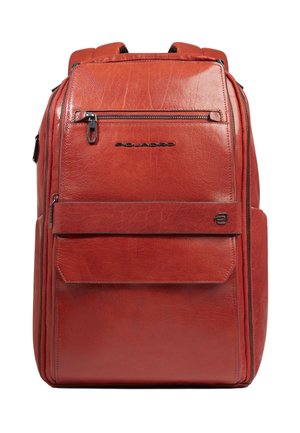 Red leather backpack with multiple zippered compartments, front pocket flap, and black metal brand logo "Piquadro" on smooth textured surface.