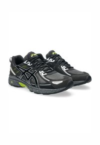 Black athletic shoes with gray mesh and synthetic overlays, featuring white accents, gel soles, and neon green details.