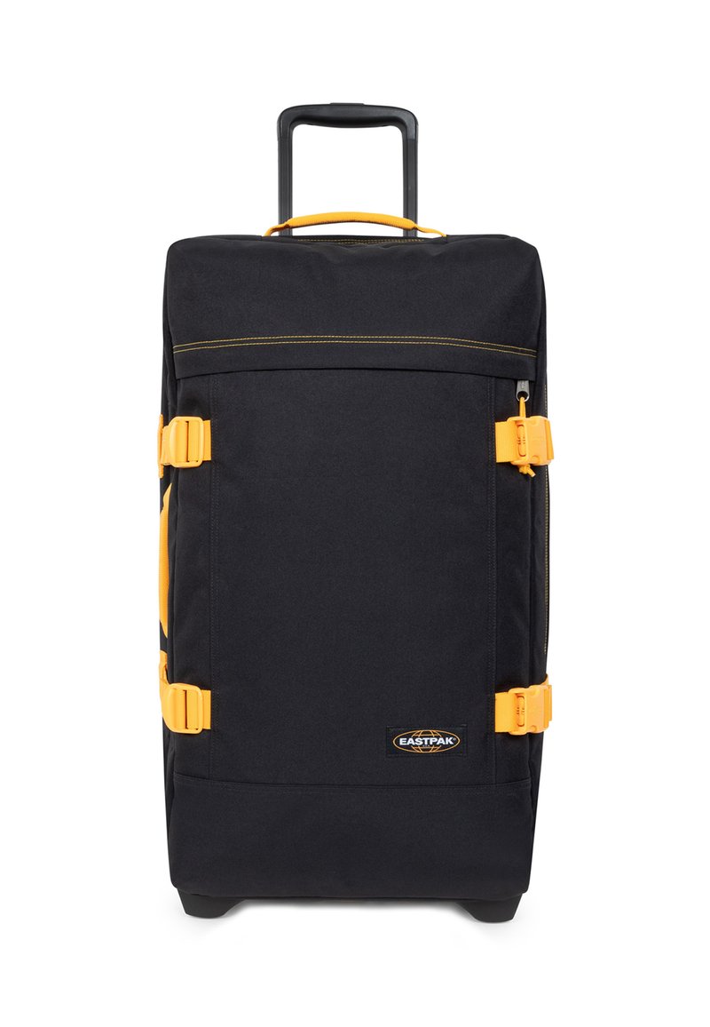 Musta matkalaukku, jossa keltaisia yksityiskohtia. Siinä on ulosvedettävä kahva, kaksi sivulenkkaria, suuri pääosasto ja kestävä kangaspinta.