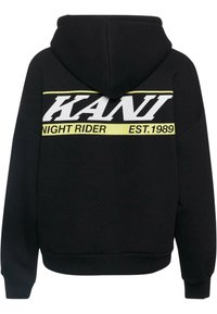 Felpa nera con un grande logo bianco "KANI" e dettagli gialli. Presenta una tasca a marsupio frontale e una vestibilità rilassata. Texture morbida.