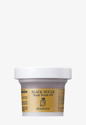 Contenant de Skinfood Black Sugar Mask Wash Off avec étiquette dorée et couvercle blanc sur fond blanc.