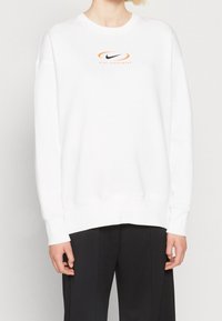 White sweatshirt made of cotton, featuring a round neckline, ribbed cuffs, and an orange and black Nike logo on the chest.