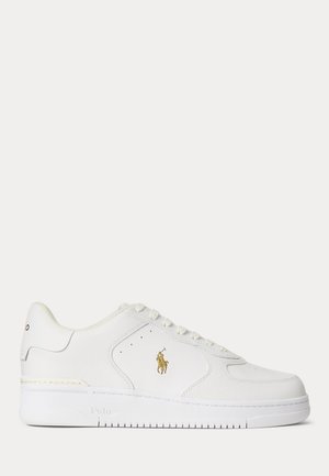 White low-top sneaker with lace-up design, textured and smooth leather panels, and gold Polo logo on side.