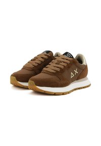 Brown suede and fabric sneakers with a padded tongue, flat laces, and a gum rubber sole. Features geometric accents on the side.