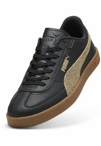 Sneaker in pelle nera con dettaglio in tinta sabbia testurizzato, lacci neri e logo dorato. Presenta una punta arrotondata e suola in gomma color caffè.