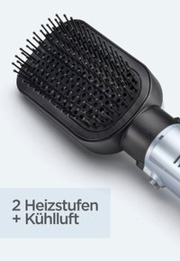 Black rectangular hairbrush with heatable bristles and silver handle, designed for two heat settings plus cool air function.
