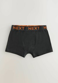 Svarta boxershorts med elastiskt midjeband som har ordet "NEXT" i orange. Materialet är mjukt med en åtsittande design.