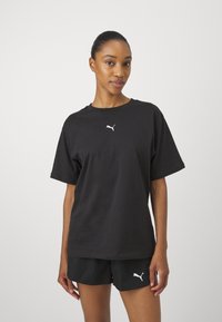 Black cotton T-shirt with short sleeves and a round neck, featuring a white Puma logo on the chest.