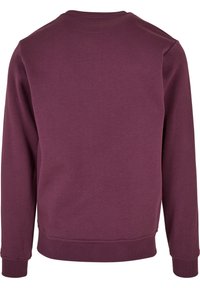 Sweat-shirt violet à manches longues et col rond avec poignets et ourlet côtelés, vu de dos.