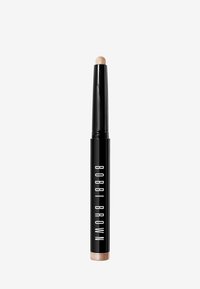 Bobbi Brown Highlighter, zylindrische schwarze Kunststoffverpackung, runder Applikator-Tip, goldene Akzentuierung am Boden, glatte Oberfläche.