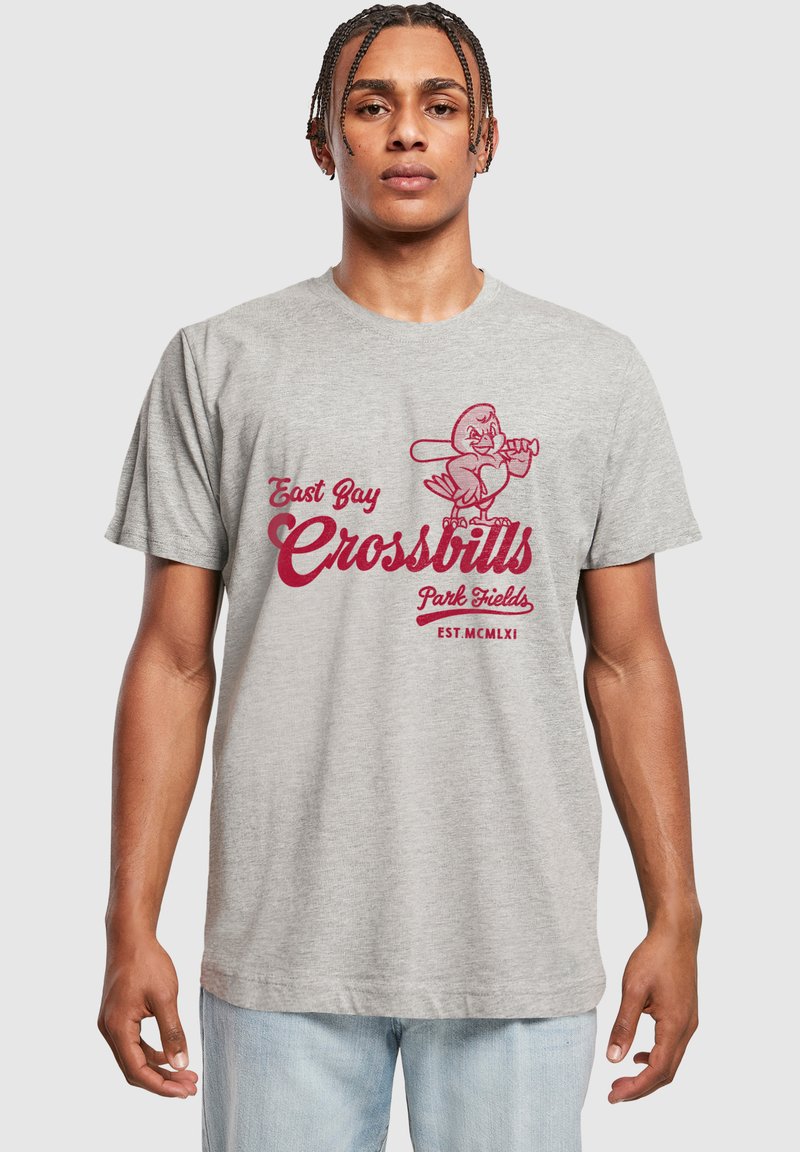 Lys grå bomull t-skjorte med et rødt grafisk design av en tegneserie-fugl som holder en kølle og teksten "East Bay Crossbills Park Fields EST. MCMLXI."