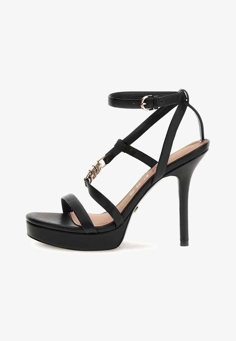 Sandale negre cu toc înalt, cu vârful închis, curele subțiri, un accent metalic și un brâu la gleznă. Design cu talpă platformă pentru un plus de înălțime.