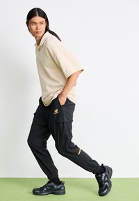 New Balance CLASSICS JOGGER - Tracksuit bottoms - black