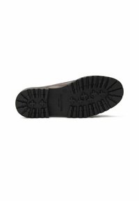 Crna gumena potplat cipele s dubokim utorima i istaknutim profilima. Ima otisnuti brend i glatku gornju ivicu.