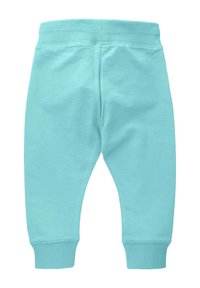 Błękitne dresy z miękkiego materiału, z ribbowanym pasem i mankietami, o zwężającym się kroju nogawek i bez widocznych wzorów.