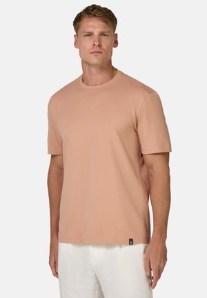 T-shirt a maniche corte, con collo tondo, di colore pesca chiaro, realizzato in tessuto morbido. Presenta un piccolo etichetta nera sul bordo.