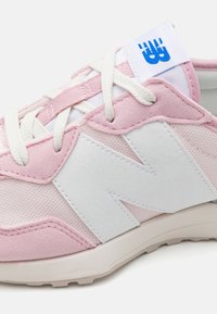Sneaker rosa con accenti bianchi, caratterizzato da una tomaia testurizzata, un grande logo bianco e lacci chiari a contrasto; materiali morbidi e suola in gomma.