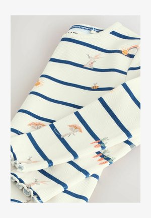 Raidallista kangasta valkoisen ja laivastonsinisen välin, jossa on brodeerattuja kuvastoja auringosta, mehiläisistä ja eläimistä. Karkea ribbikangas, jossa on rypytty helma.