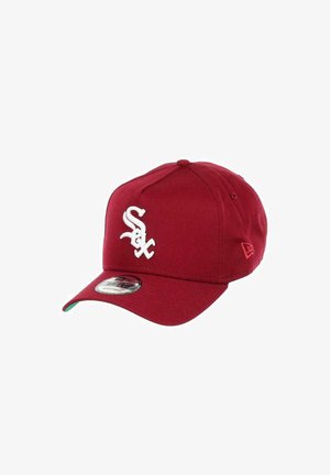 Red baseball cap made of fabric with a curved brim, featuring a white embroidered logo on the front and a green underside on the brim.