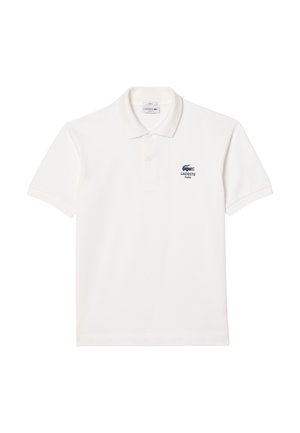 White cotton polo shirt featuring a buttoned placket and short sleeves. Lacoste logo in navy on the left chest. Smooth texture.