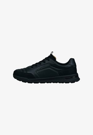 Black athletic shoe with a smooth leather upper, textured accents, and a padded collar. Features a lace-up design and rubber sole.