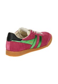 Pink suede sneaker with green synthetic accents, white laces, and a black heel. Features a textured gum rubber sole for grip.