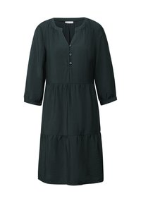 Tummanvihreä kerroksellinen mekko, joka on valmistettu kevyestä kankaasta. Mekossa on kolmanneslievet, V-pääntie ja nappidetailit edessä.