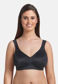 Sostenedor negro con un acabado suave, con tirantes anchos y un diseño en forma de V. Fabricado con material elástico para mayor comodidad y soporte.